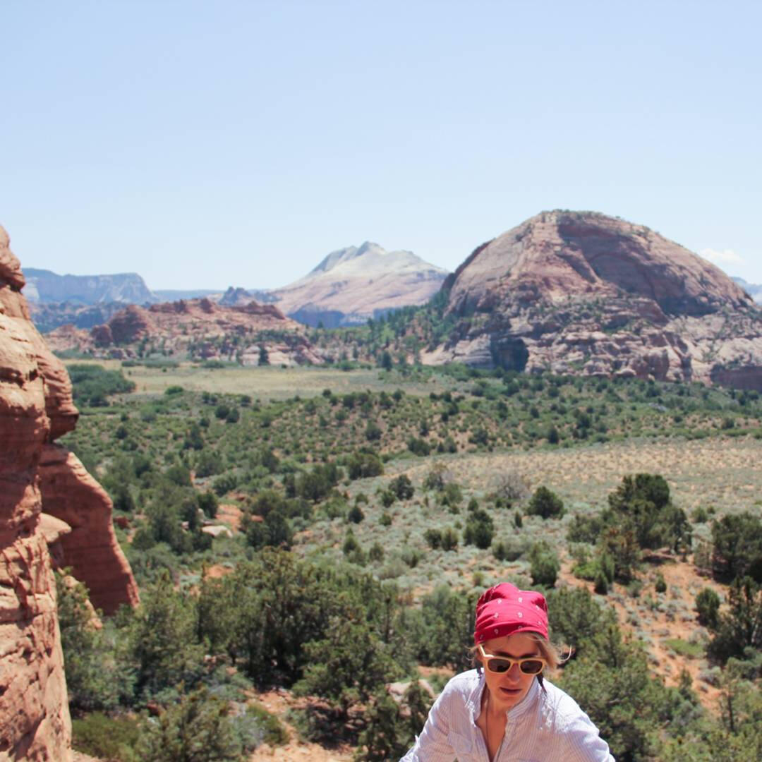A young woman climbs a mountain in the desert of Utah, Zion National Park