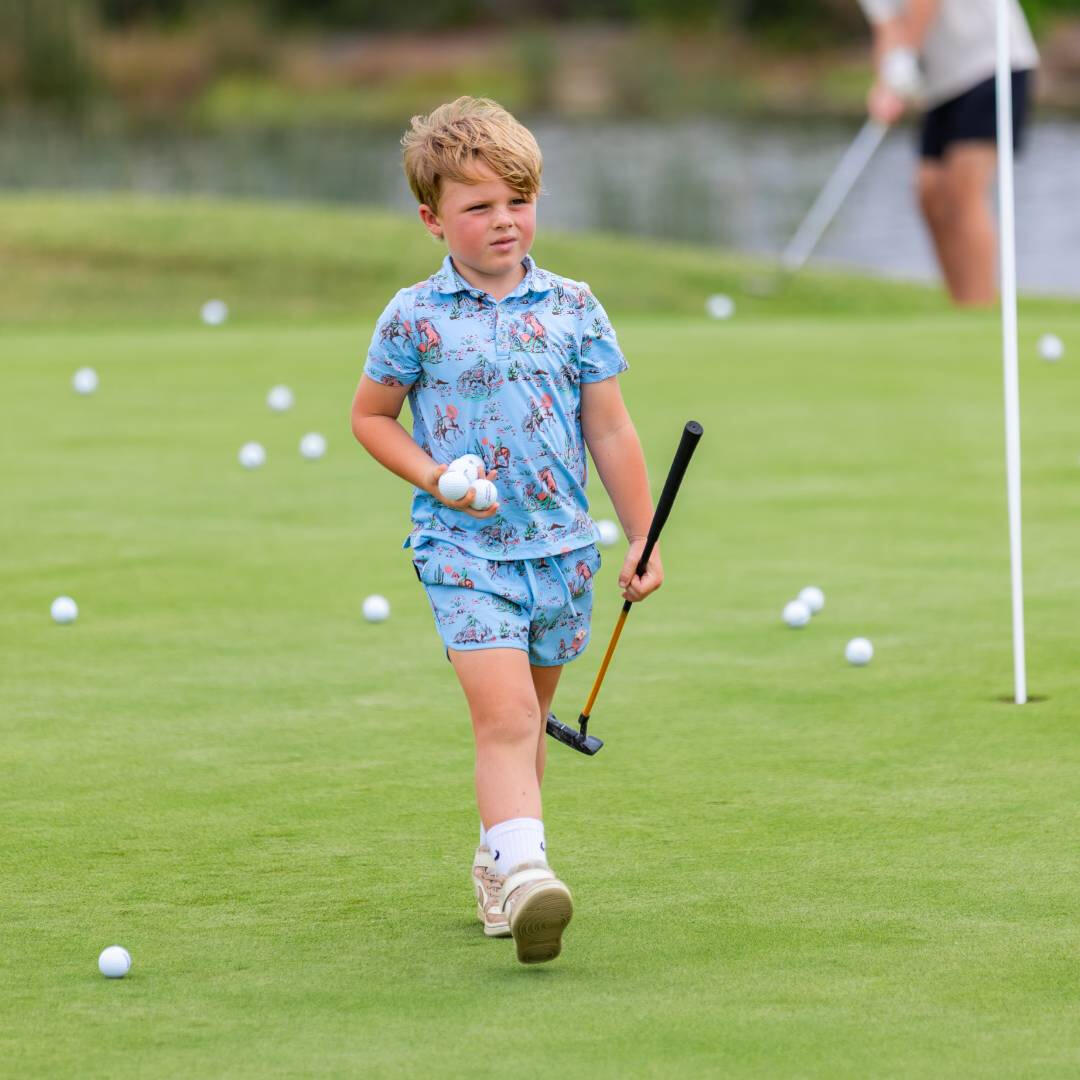 A young boy on a golf course